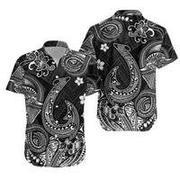 Black Hawaiian shirt with white Polynesian tribal fish and floral motifs, short sleeves