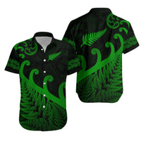 Green short-sleeve button-up shirt with fern and koru swirl tropical print