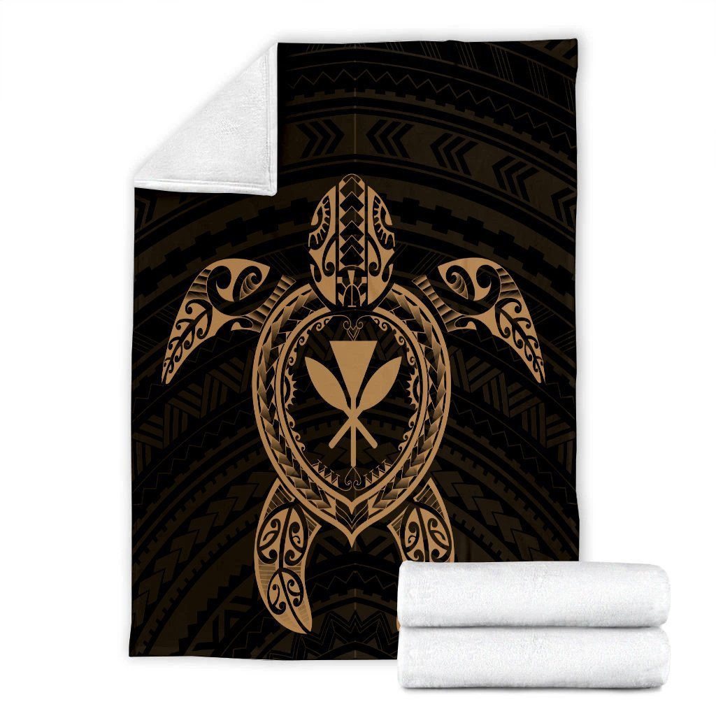 Folded black blanket set with gold turtle emblem plus white rolled blanket