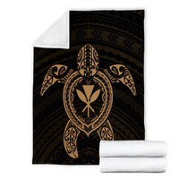 Folded black blanket set with gold turtle emblem plus white rolled blanket