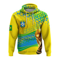 Yellow pullover hoodie with Brazil crest, geometric pattern, and trophy graphic on front