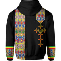 Black hoodie back with colorful patterned panels and cross-shaped emblem under hood