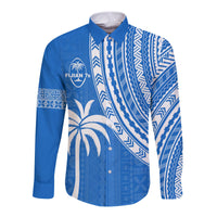 Unisex blue long-sleeve button shirt with white geometric patterns, palm motifs, and crest graphic