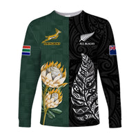 Long-sleeve rugby shirt with green front, black side, gold protea artwork and fern pattern