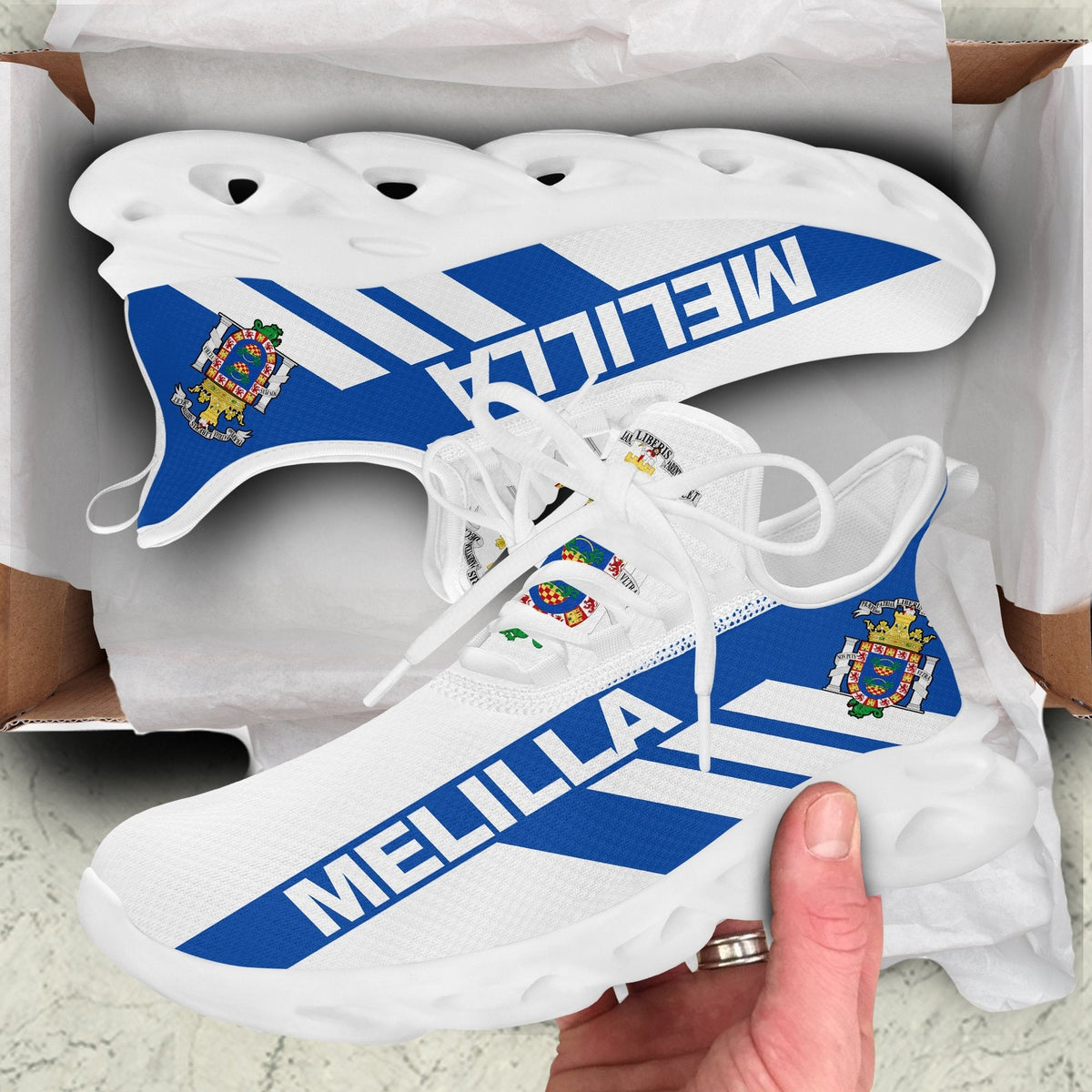 White clunky sneakers with MELILLA blue stripe graphic, white laces and perforated sole