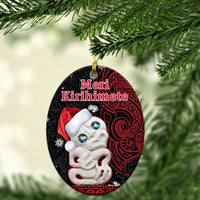 Oval red and black ceramic ornament with Santa face, white hat, “Meri Kirihimete” text