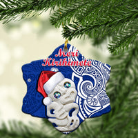 Blue heart-shaped ceramic Christmas ornament with Hei Tiki and “Meri Kirihimete” text
