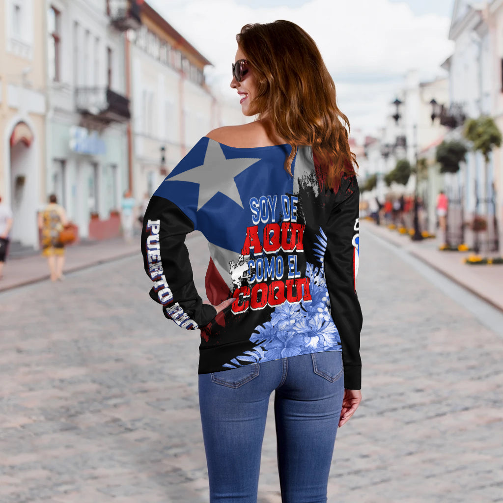 Off-shoulder sweater back print with blue star and red text graphic over dark fabric