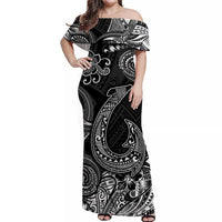 Black off-shoulder maxi dress with large white tiki fish and wave swirl prints