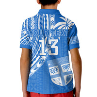 Blue polo shirt back view with 'YOUR TEXT' and number 13, shield emblem detail