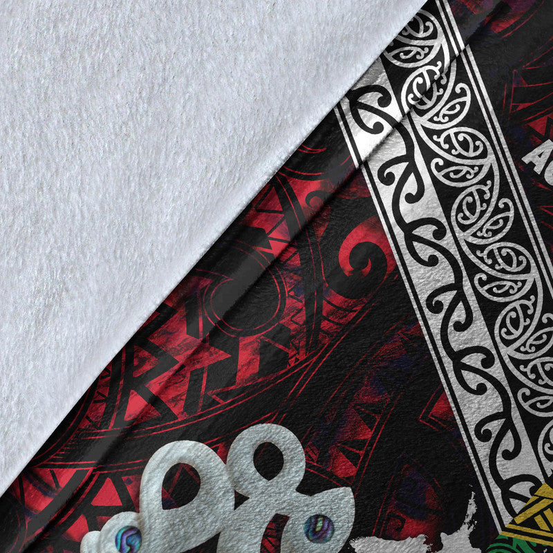 Close-up of patterned fleece blanket edge with white motifs, black and red sections