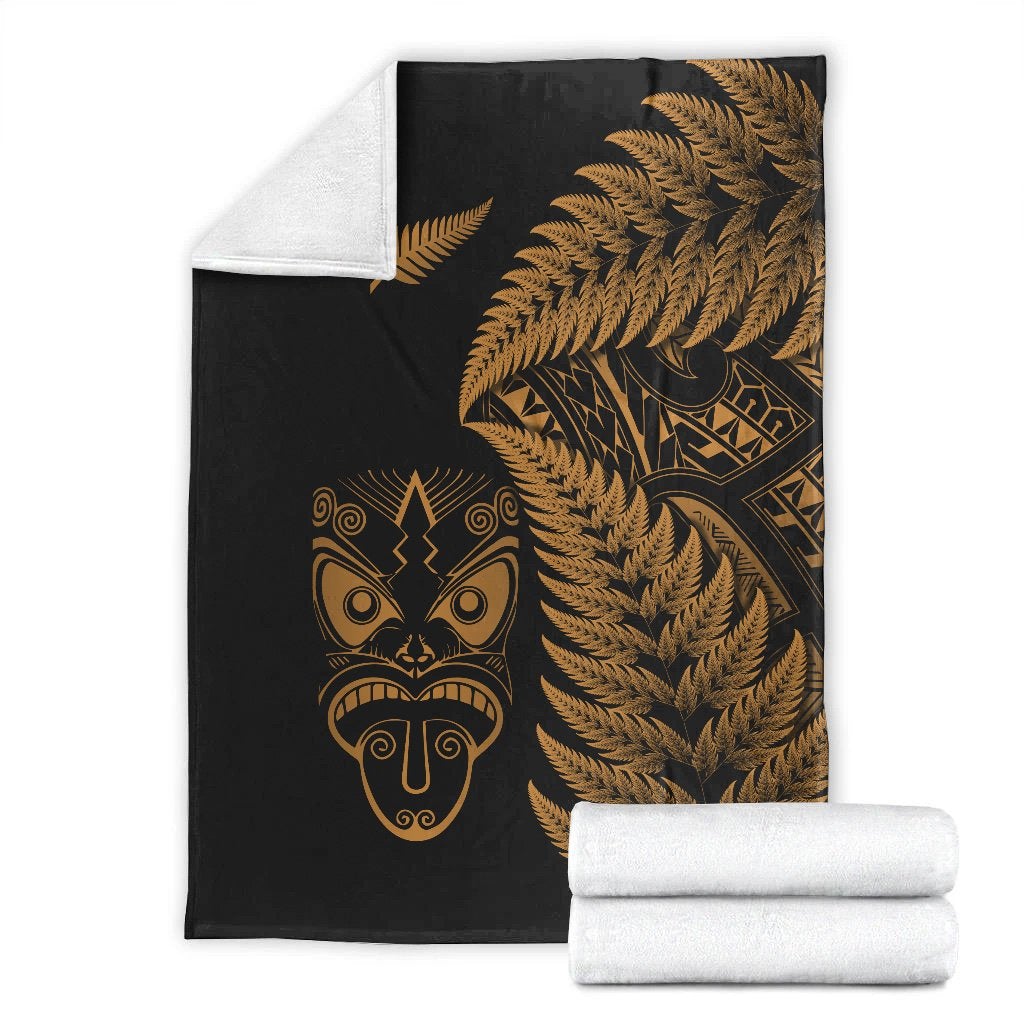 Black and gold Maori-style blanket set, with white-wrapped roll and fern mask print
