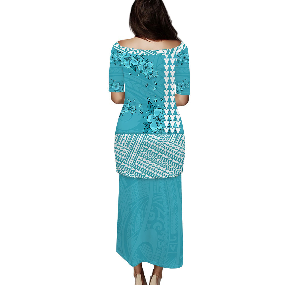 Turquoise long dress with floral and geometric Polynesian pattern, back view