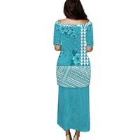 Turquoise long dress with floral and geometric Polynesian pattern, back view