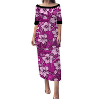 Pink long hibiscus print dress with purple tapa pattern and black neckline trim