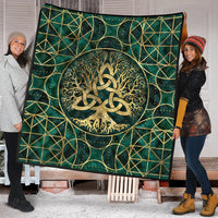 Teal Viking quilt with large gold Tree of Life medallion, triquetra, lattice lines