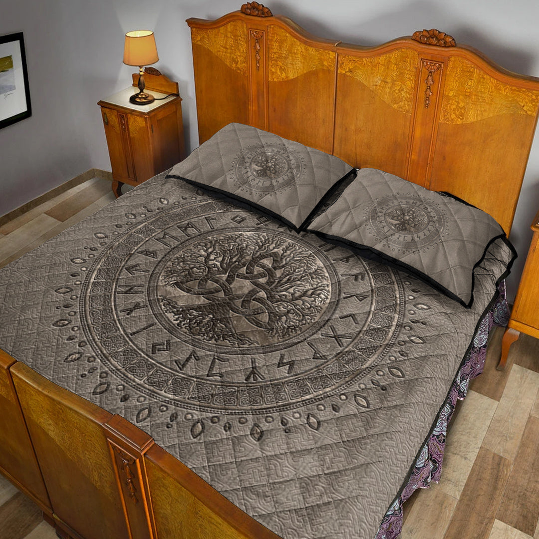Light beige Viking quilt with dark Tree of Life medallion, two pillows, and patterned border