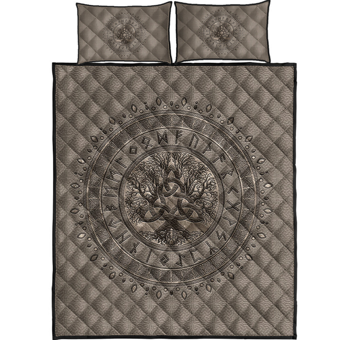 Folded light beige Viking quilt bed set with dark Tree of Life circular medallion and two pillows