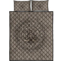 Folded light beige Viking quilt bed set with dark Tree of Life circular medallion and two pillows
