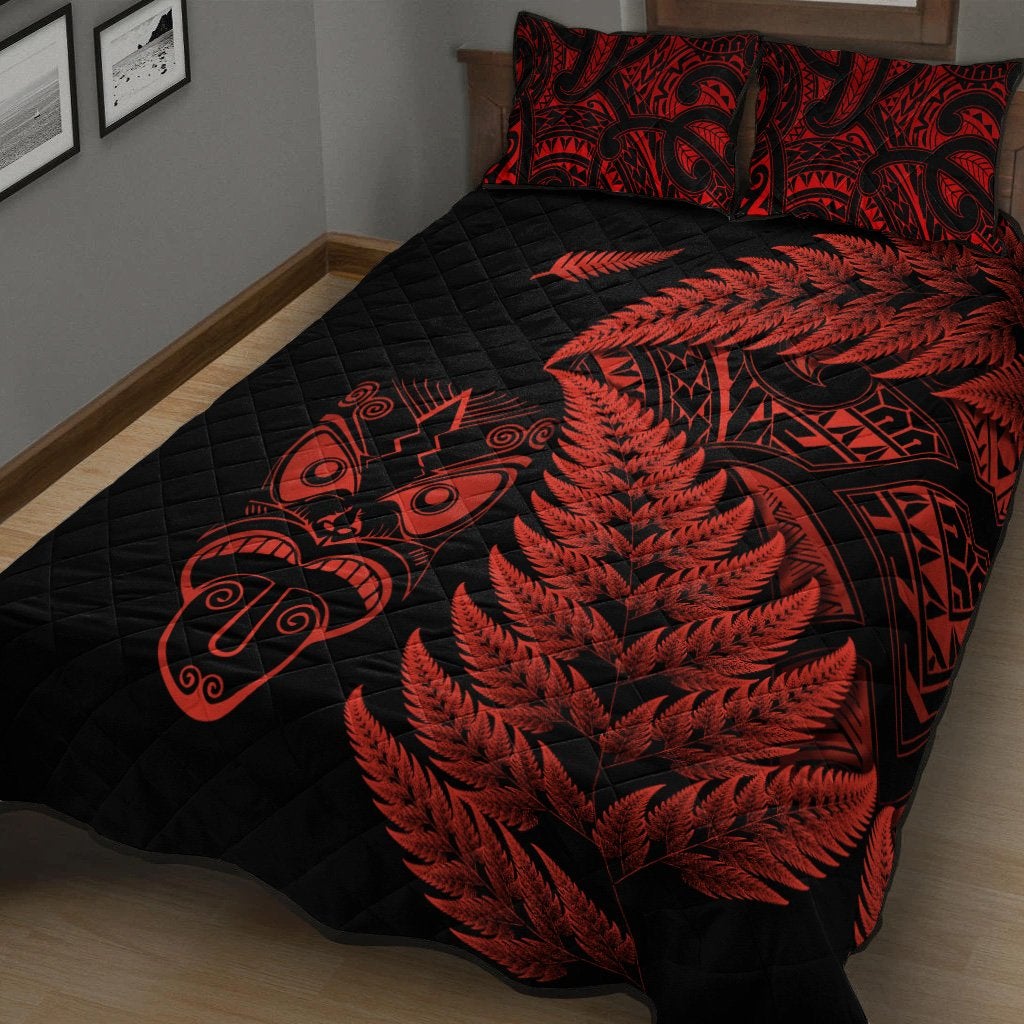 Black quilt bed set with large red fern and geometric motifs, plus matching pillow