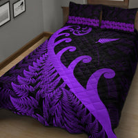 Purple and black quilt bed set with large koru swirl and fern print, matching pillows
