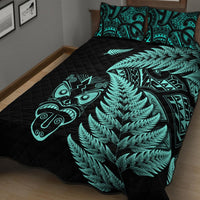 Black quilt with turquoise fern canopy, Maori mask art, and matching turquoise-pattern pillows