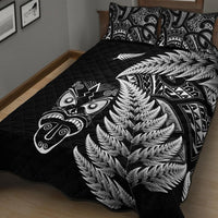 Black quilt bed set showing large silver fern pattern over quilt stitching