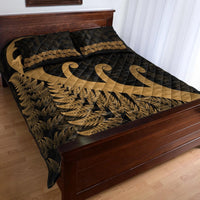 Black quilt bed set with gold fern leaf filling and large koru scroll applique in center
