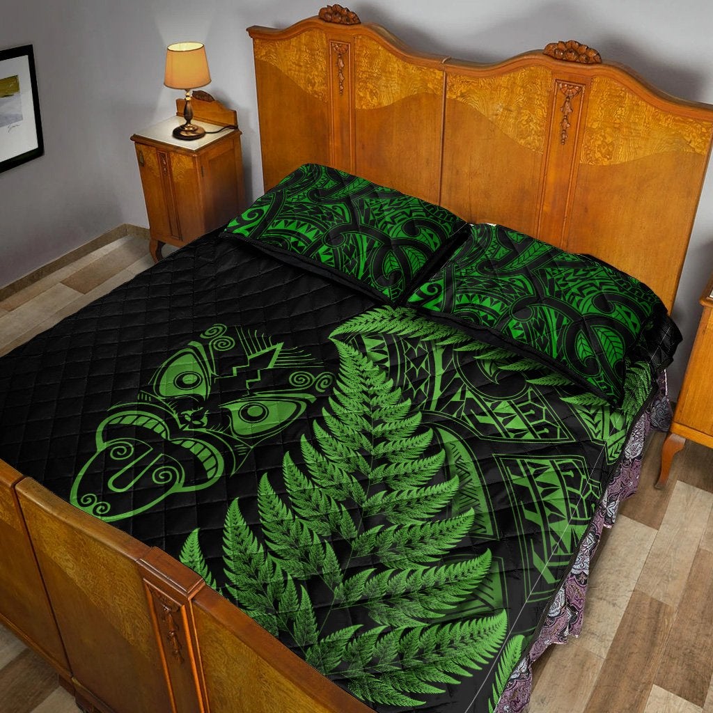Black quilt bed set with neon-green fern leaves and tribal pattern across the bed, pillow on top