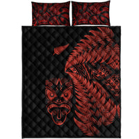 Black quilt with red fern and Maori face print, two matching square pillows