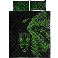 Black quilt with neon-green fern and tiki motifs, plus two green-patterned pillowcases