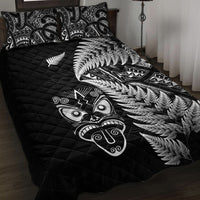 Black quilt bed set with silver fern print and Maori face motifs, with matching pillow