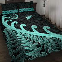 Dark quilt bed set with turquoise fern leaves and large koru swirl centerpiece
