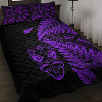 Black quilt with purple fern and tribal face print and two purple-pattern pillowcases