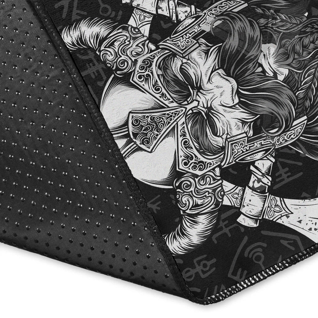 Close-up of black Viking area rug edge with white Odin warrior illustration and rune symbols