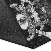 Close-up of black Viking area rug edge with white Odin warrior illustration and rune symbols