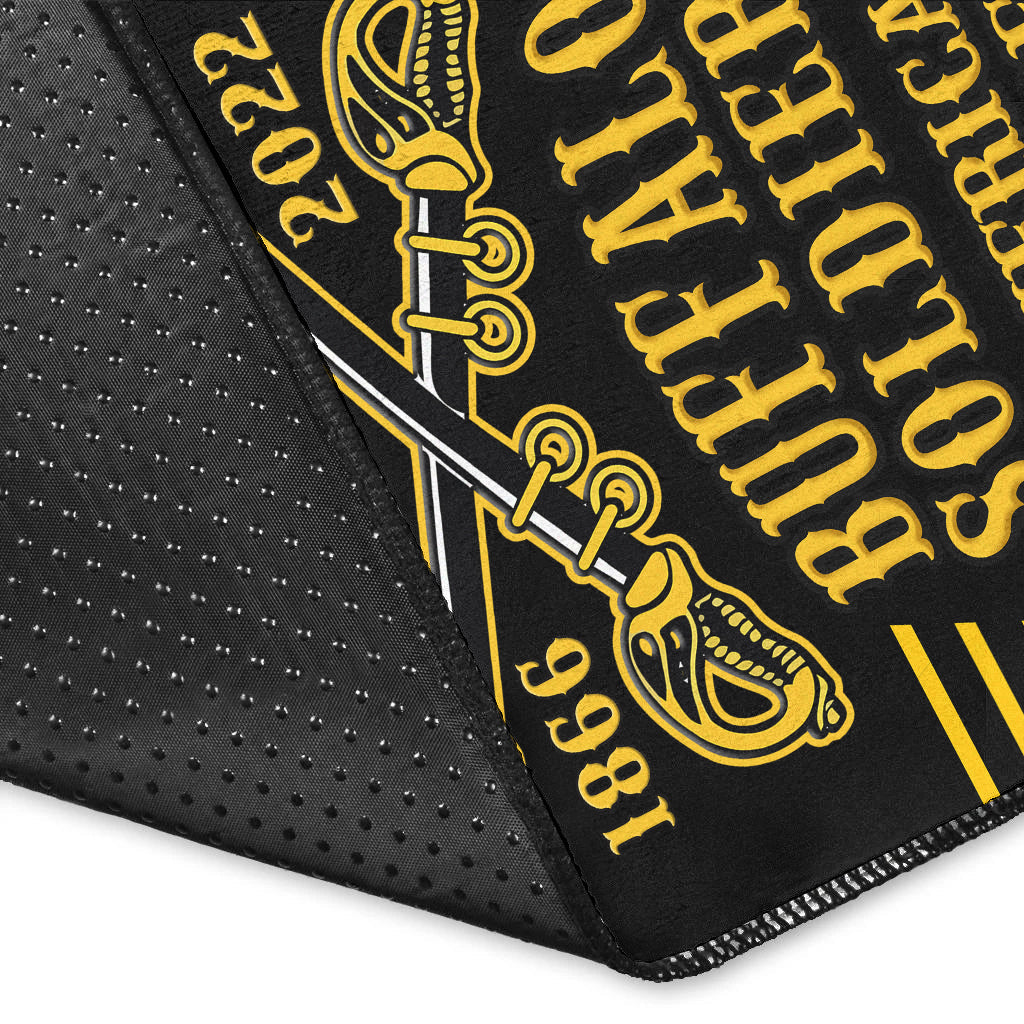 Black rug corner close-up with gold 'YOUR TEXT' print and stitched edge