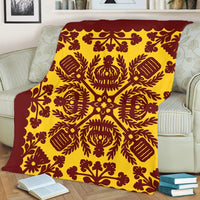 Red and yellow quilt-style blanket full pattern view with scalloped top edge