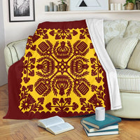 Red and yellow quilt-style blanket with ornate floral medallion pattern and scalloped edge
