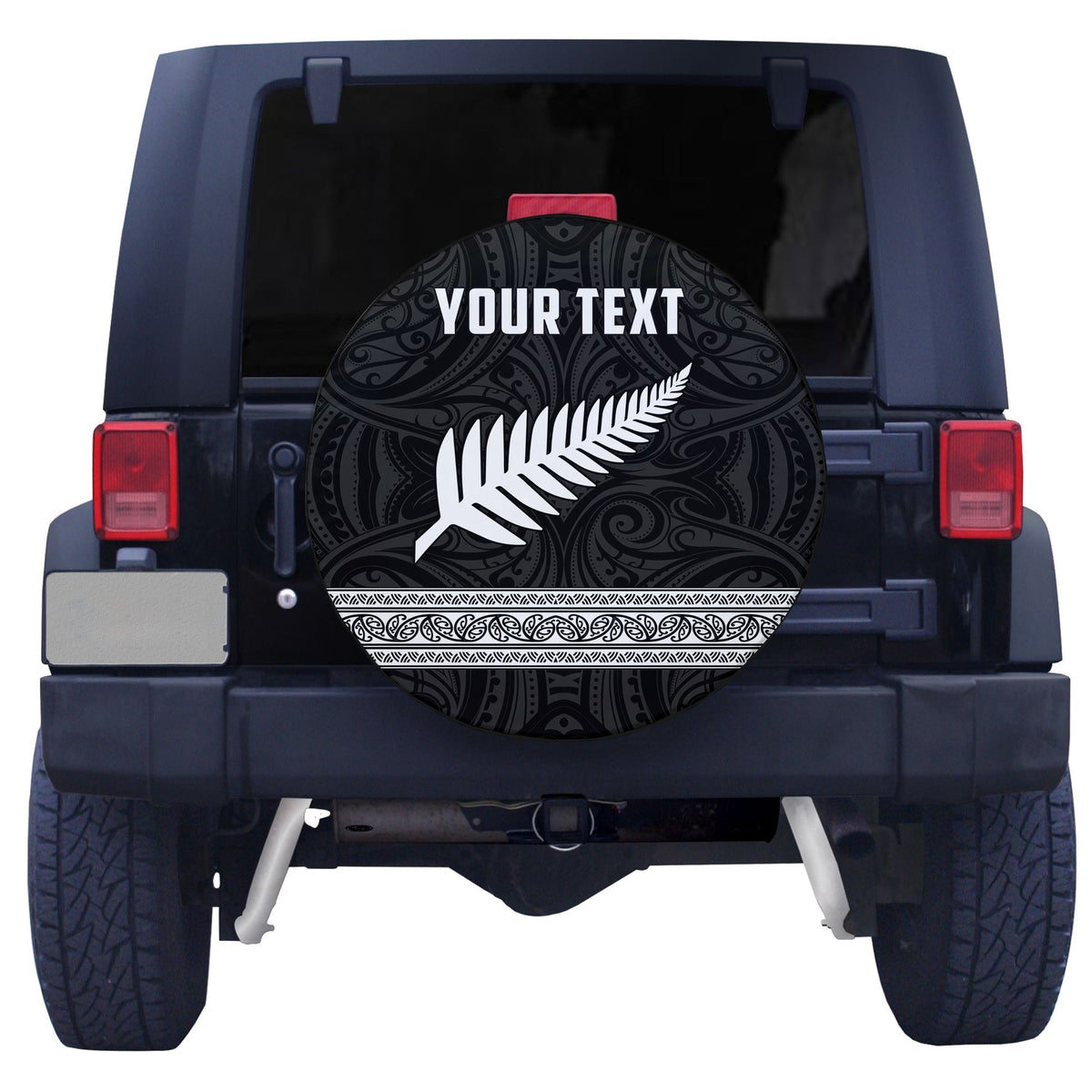 Black circular spare tire cover with white fern design and ornate swirls, 'YOUR TEXT'
