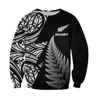 Black rugby sweatshirt with feather graphic, RUGBY logo, and Maori-style sleeve print