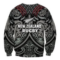 Black rugby sweatshirt with Maori-inspired pattern and “New Zealand Rugby” text front