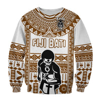 Unisex rugby sweatshirt in brown-and-white tribal print with FIJI BATI text and seated figure