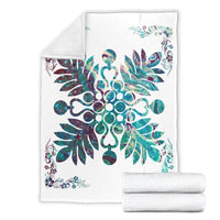 Folded shell white blanket with teal and purple hibiscus floral motif; rolled extras