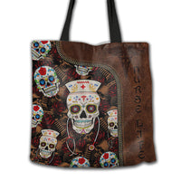 Brown leather-style tote bag with sugar skull nurse print, top zipper, black handles