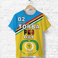 Blue Torba T-shirt with front graphic: 02 October TORBA PNG DAY and circular emblem