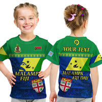 Green kids T-shirt with front graphic: Malampa Fiji, crest, flag patch & floral print