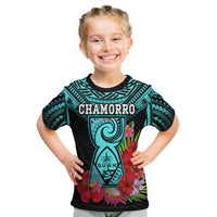 Kids turquoise and black T-shirt with CHAMORRO and guam figure surrounded by flowers.