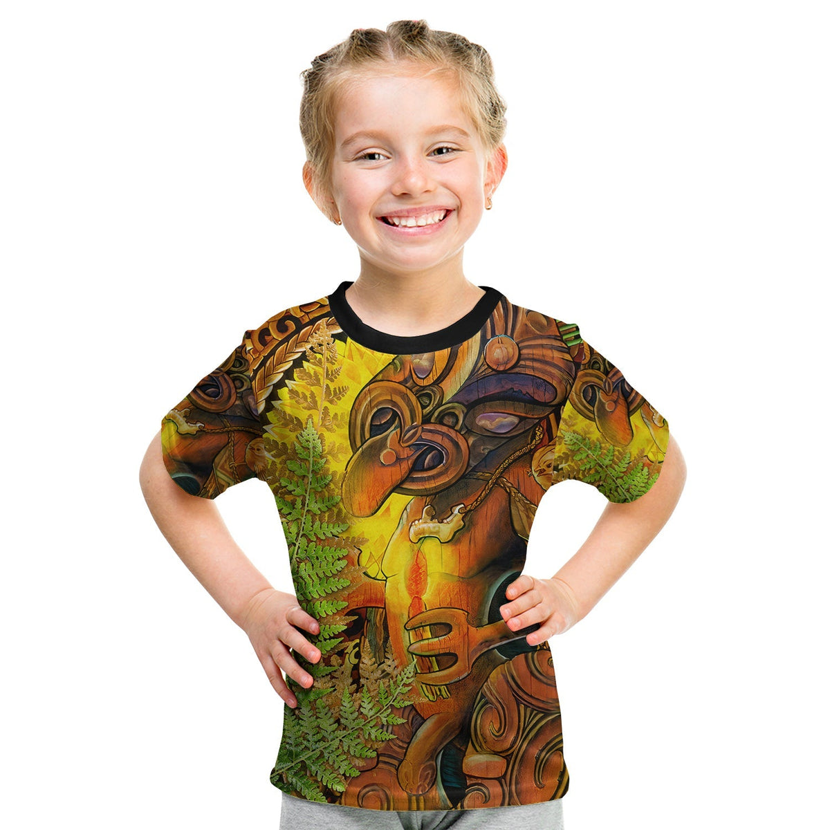 Kids graphic t-shirt in brown, green and yellow with tiki-style artwork and black collar