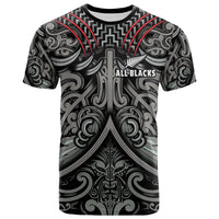 Black rugby T-shirt with Maori-style tribal print and red accents, front graphic.